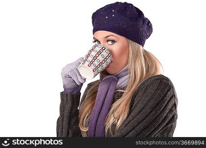beautiful and natural blonde girl holding a hot cup of tea wearing a purple knitted cap and scarf and gloves