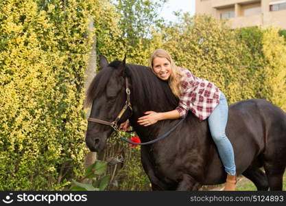 Beautiful and natural young woman spending sometime with her horse