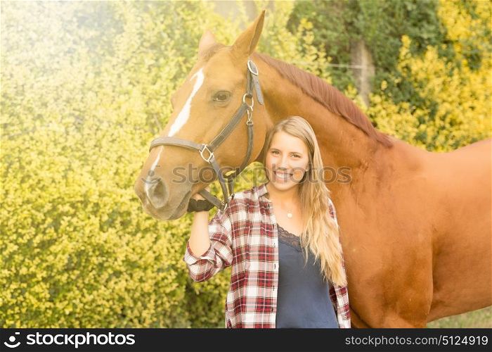 Beautiful and natural young woman spending sometime with her horse
