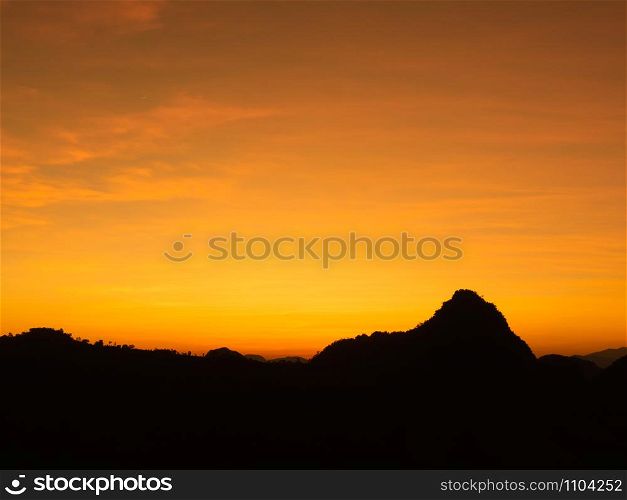 Beautiful and peaceful scenery of sunset at the mountain range in the rural area.