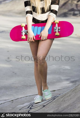 Beautiful and sexy street girl with her skateboard