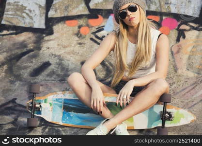 Beautiful and sexy street girl with her skateboard