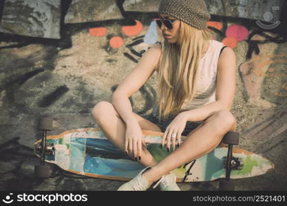 Beautiful and sexy street girl with her skateboard