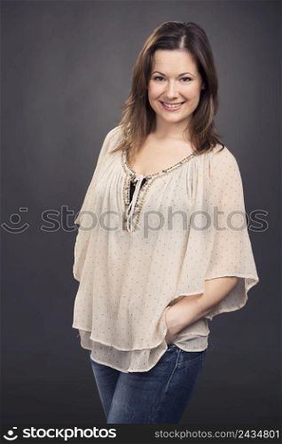 Beautiful and smiling woman posing in studio