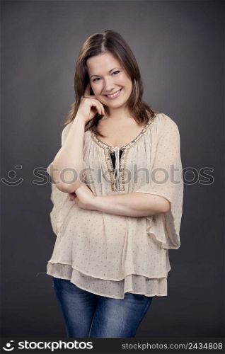 Beautiful and smiling woman posing in studio