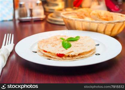 beautiful and tasty quesadilla with chicken in a restaurant