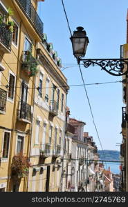 beautiful and traditional view of antique building and lamp in Lisbon, Portugal (river tagus background)