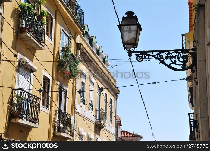 beautiful and traditional view of antique building and lamp in Lisbon, Portugal (river tagus background)