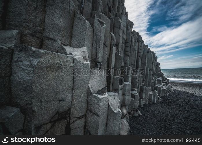 Beautiful and unique volcanic rock formation on Iceland black sand beach located near the village of Vik i myrdalin South Iceland. Hexagonal columnar rocks attract tourist who visit Iceland.