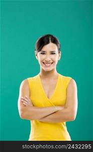 Beautiful and young asian woman smiling, over a green background