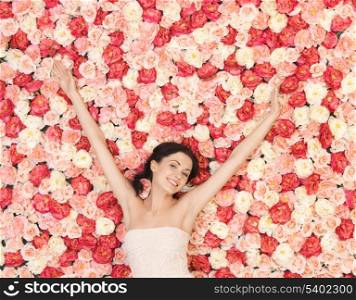 beautiful and young woman with background full of roses