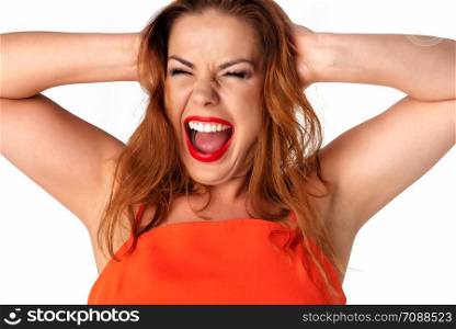 Beautiful and young woman with perfect teeths is expressing her emotions and screaming.