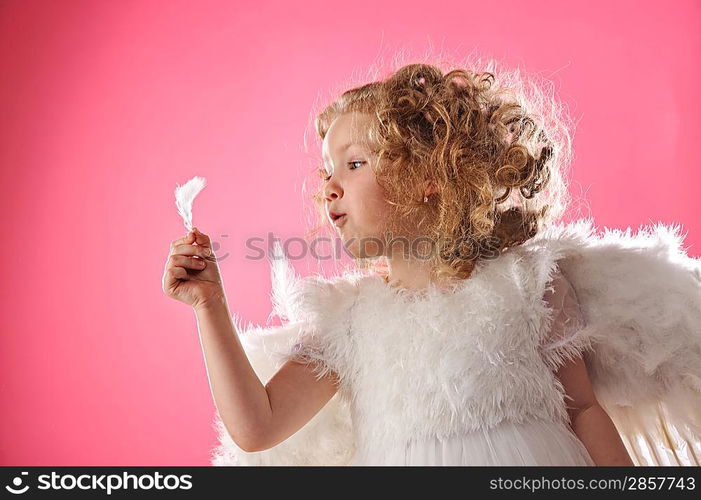 Beautiful angel girl holding a feather