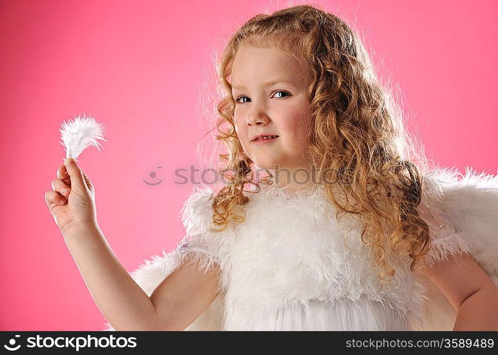 Beautiful angel girl holding a feather