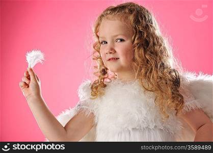 Beautiful angel girl holding a feather
