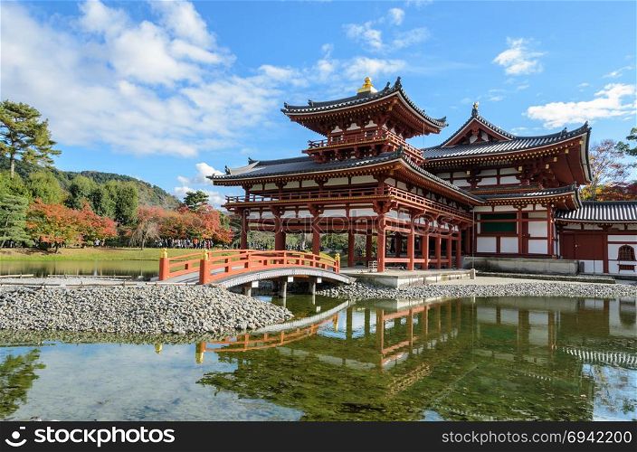 Beautiful architecture of Phoenix Hall with autumn color in Byodo-in temple which is a Buddhist temple in Uji city, Kyoto Prefecture, Japan