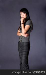 Beautiful Asian American business career woman standing in grey casual clothes with arm crossed and hand on chin, thinking, isolated.