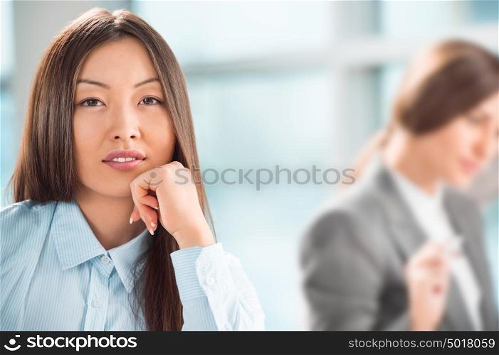 Beautiful asian business woman relaxing during a meeting at office with her colleagues