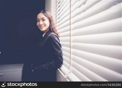 Beautiful Asian business women are smiling and working happy on office background