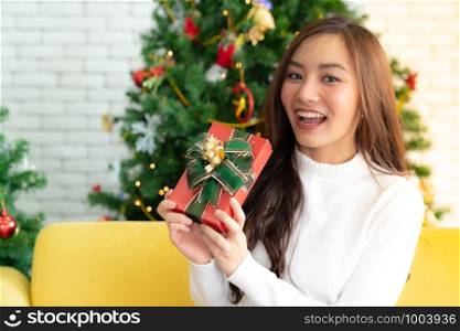 beautiful asian girl hold christmas gift box present for Christmas holiday season greeting.