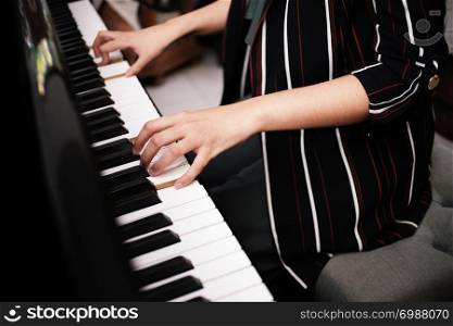 Beautiful asian girl learn to play piano