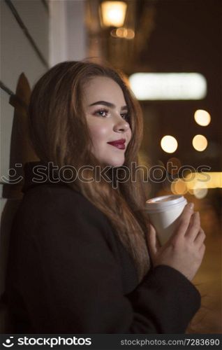 beautiful asian girl with coffee at night walking in the city