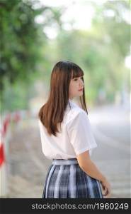 beautiful asian japanese school girl uniform looking at park outdoor