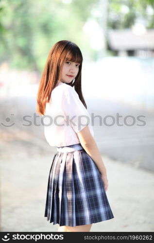 beautiful asian japanese school girl uniform looking at park outdoor