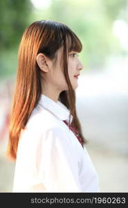 beautiful asian japanese school girl uniform looking at park outdoor