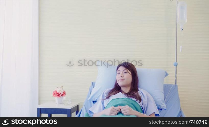 Beautiful Asian patient sick and sleeping while staying on Patient's bed at hospital. Medicine and health care concept.