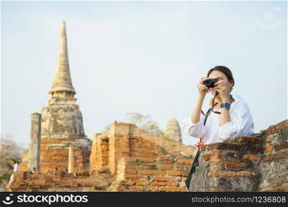 Beautiful Asian tourists Walking, taking photos and traveling on holidays The old town, world heritage city Ayutthaya kingdom Phra Nakhon Si Ayutthaya, Thailand
