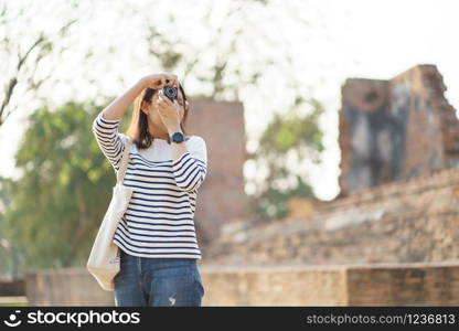 Beautiful Asian tourists Walking, taking photos and traveling on holidays The old town, world heritage city Ayutthaya kingdom Phra Nakhon Si Ayutthaya, Thailand