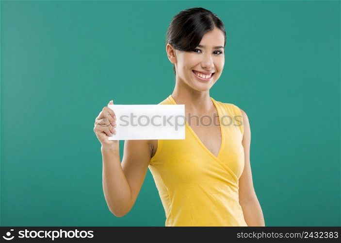 Beautiful asian woman holding a white paper card, over a green background