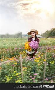 Beautiful asian woman holding bouquet flowers , Portrait in nature field. happy farmers