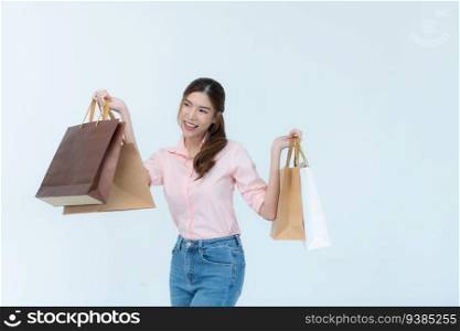 Beautiful asian woman holding shopping bags isolated on white background.