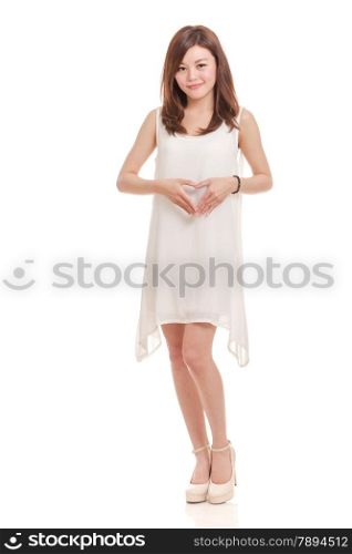 Beautiful Asian woman in white dress smiling with hands in heart shape