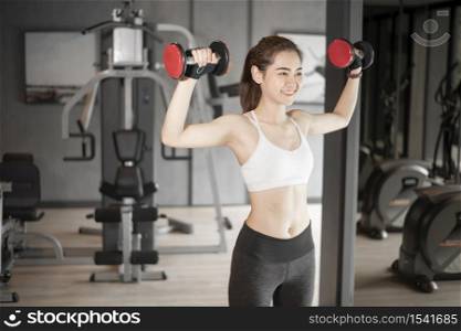 Beautiful asian woman is doing exercise in the gym