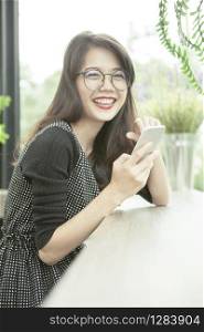 beautiful asian woman laughing face happiness emotion with smart phone in hand