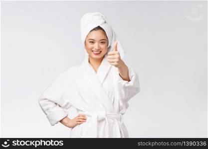 Beautiful asian woman perfect skin showing thumbs up isolated on white background. Beautiful asian woman perfect skin showing thumbs up isolated on white background.