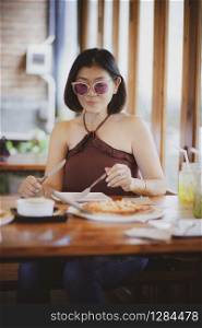 beautiful asian woman ready to eating western food meal