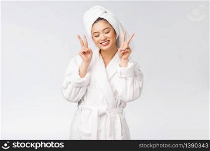 Beautiful asian woman showing peace sign or two finger with happy feeling. Isolated over white background. Beautiful asian woman showing peace sign or two finger with happy feeling. Isolated over white background.