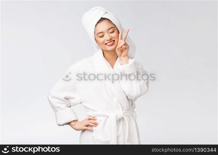 Beautiful asian woman showing peace sign or two finger with happy feeling. Isolated over white background. Beautiful asian woman showing peace sign or two finger with happy feeling. Isolated over white background.