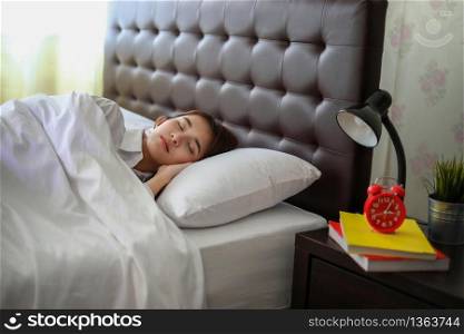 beautiful Asian woman sleeping in white bed.