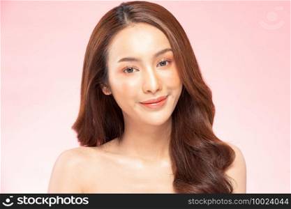 Beautiful Asian woman smile with clean and fresh skin Happiness and cheerful with positive emotional,isolated on pink background,Beauty Cosmetics and spa Treatment Concept