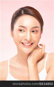 Beautiful Asian woman touching neck smile with clean and fresh skin Happiness and cheerful with positive emotional,isolated on pink background,Beauty Cosmetics and spa Treatment Concept