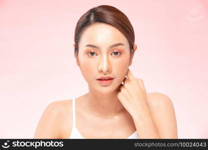 Beautiful Asian woman touching soft cheek smile with clean and fresh skin Happiness and cheerful with positive emotional,isolated on pink background,Beauty Cosmetics and spa Treatment Concept