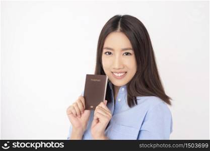 Beautiful Asian woman tourist is holding passport on white background
