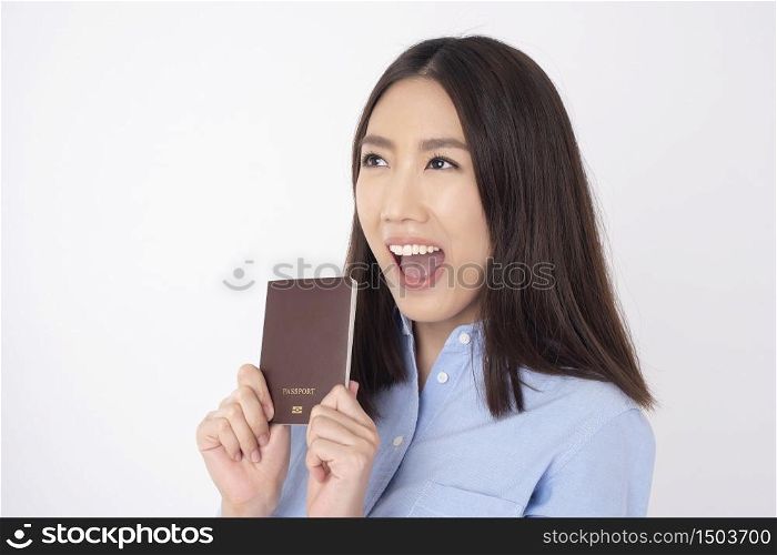 Beautiful Asian woman tourist is holding passport on white background