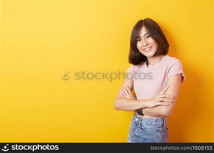 Beautiful asian woman University student happy on yellow background