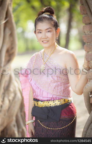 beautiful asian woman wearing thai tradition clothes toothy smiling face in ayutthaya world heritage site of unesco